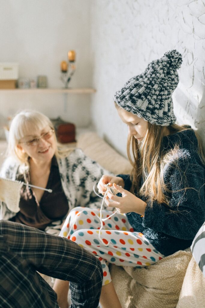 a girl wearing beanie doing crochet