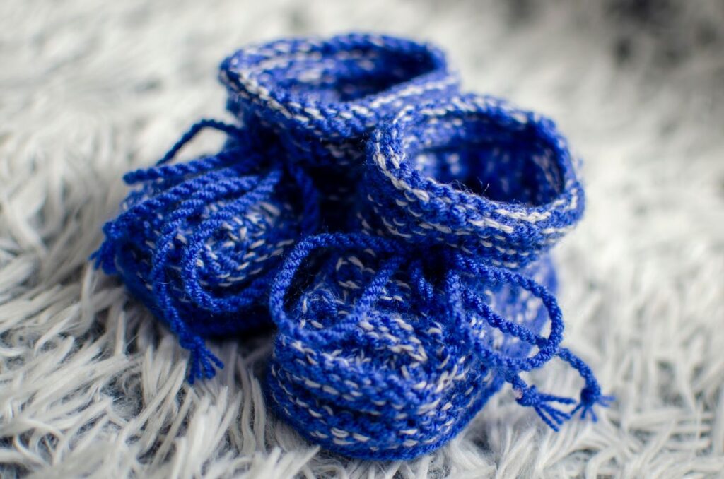 A close up shot of a pair of crocheted shoes