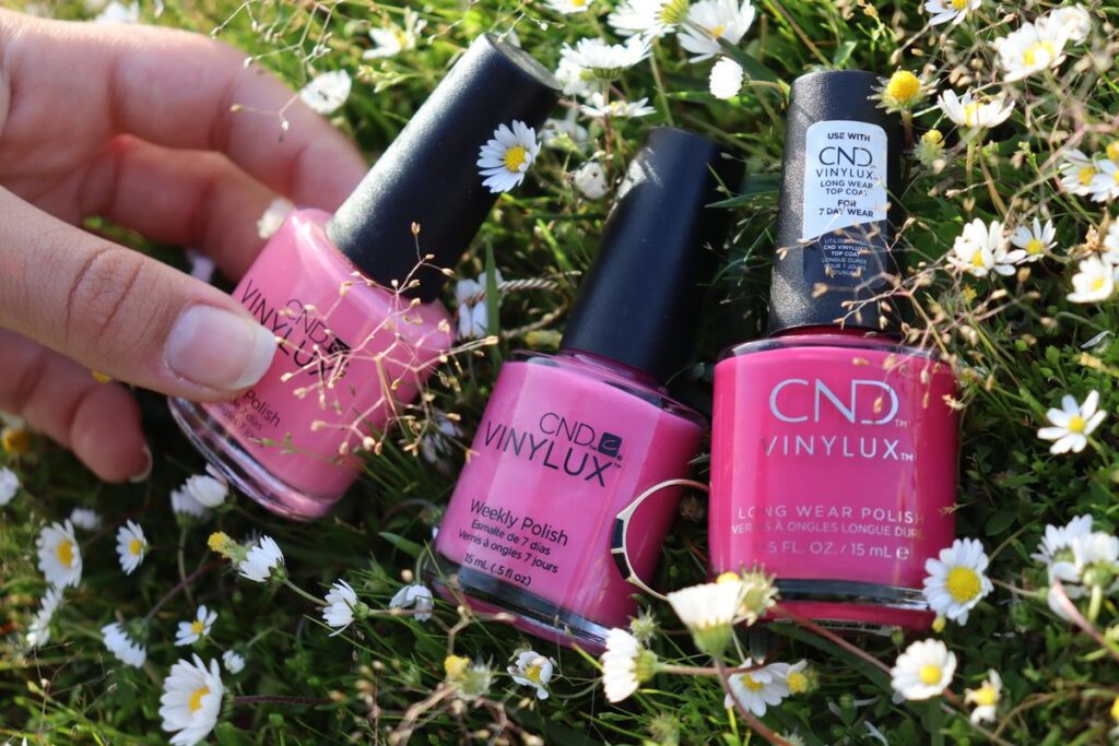 Bottles of nail polish on meadow