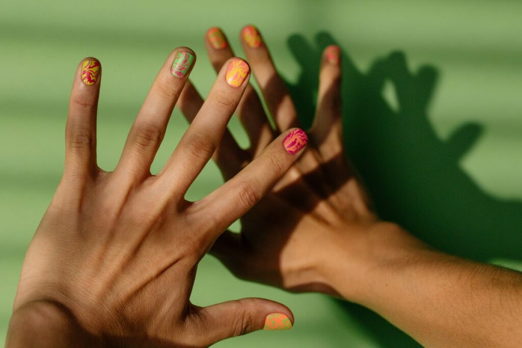 Close up shot of hands with colorful nail polish