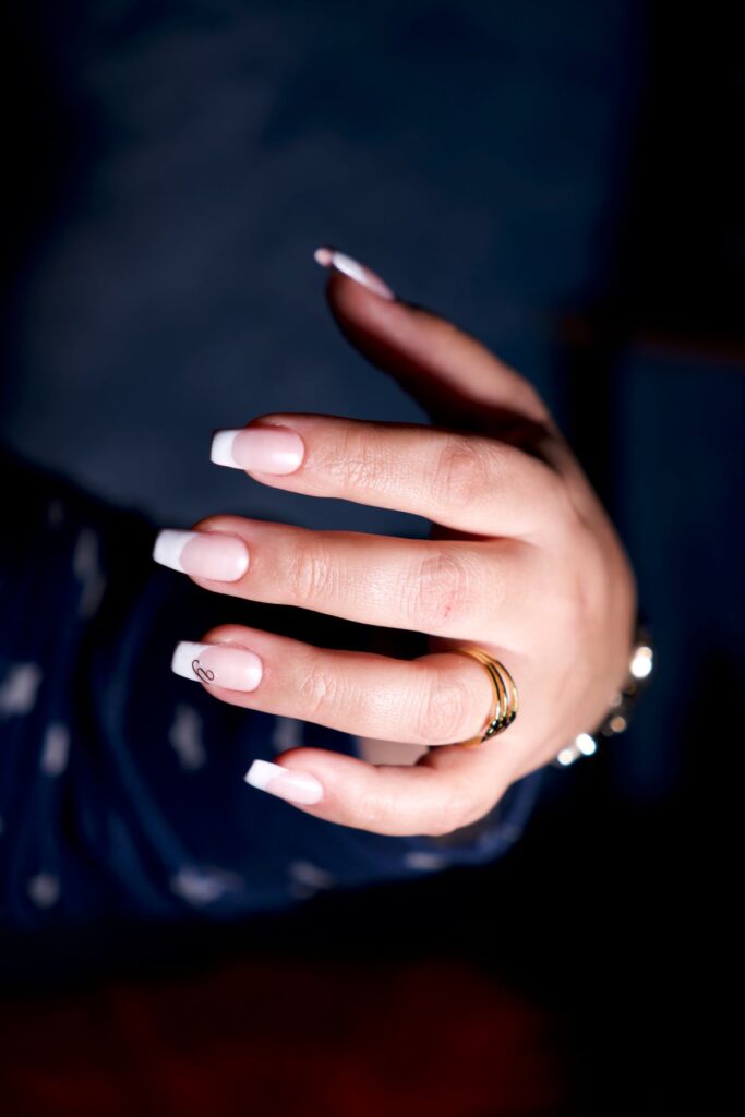 Elegant hand with french manicure and jewelry