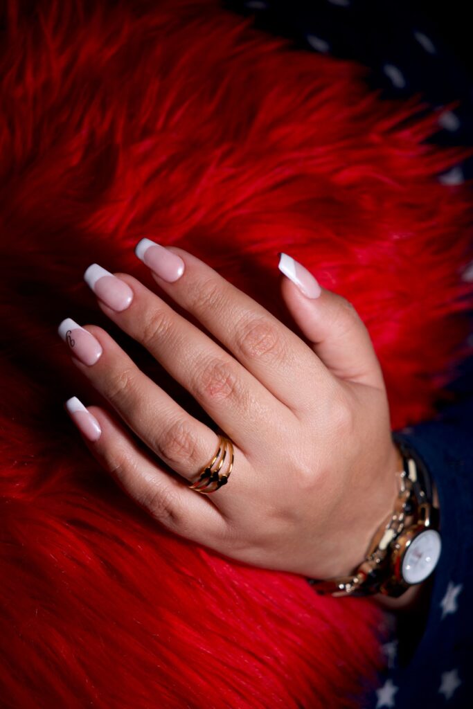 Elegant hand with french manicure and jewelry