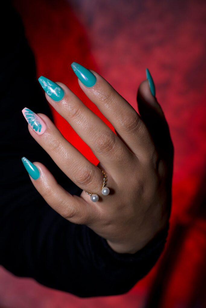 Elegant hand with turquoise nails and ring