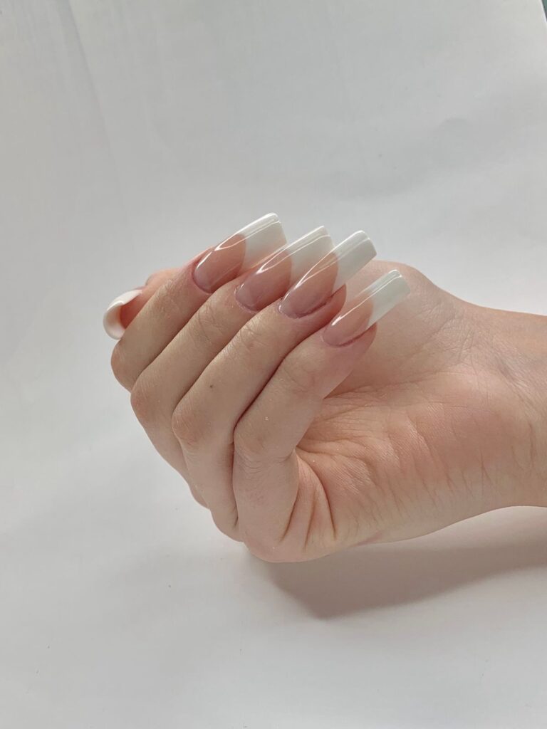 Hand with french tip nails