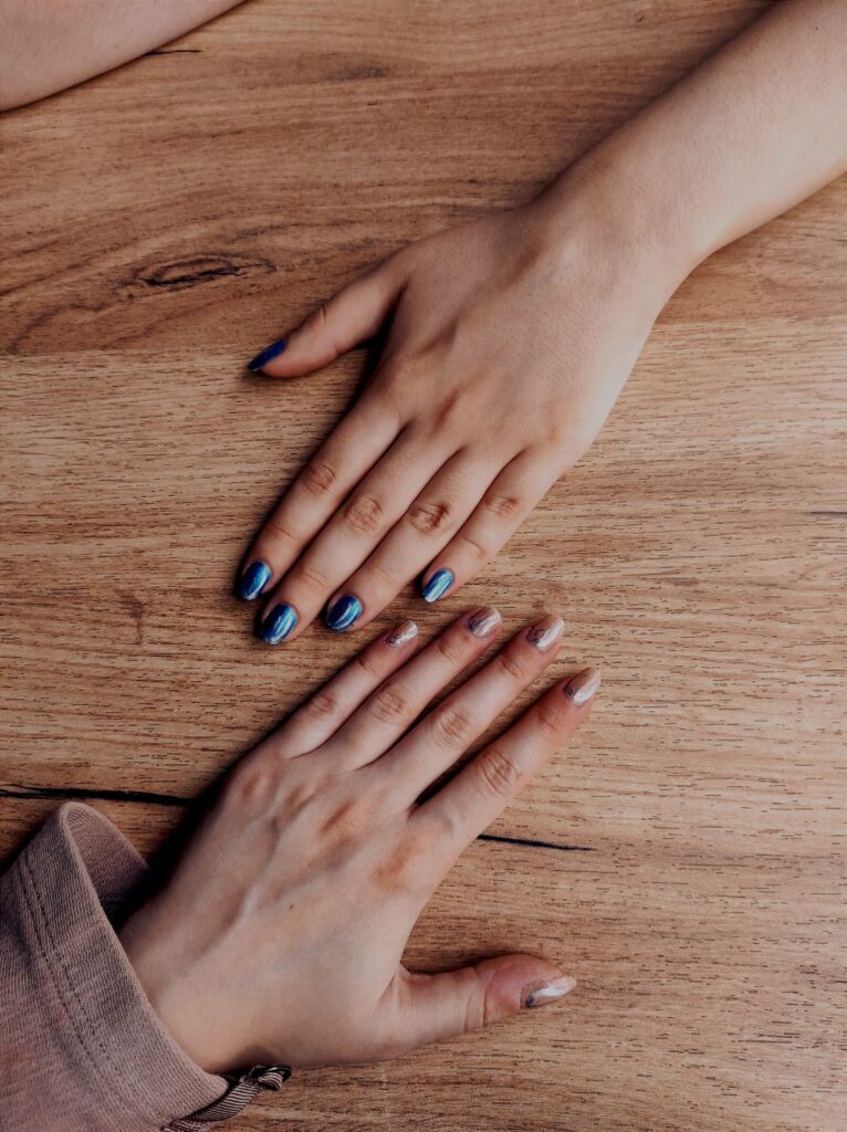 Two hands with painted nails