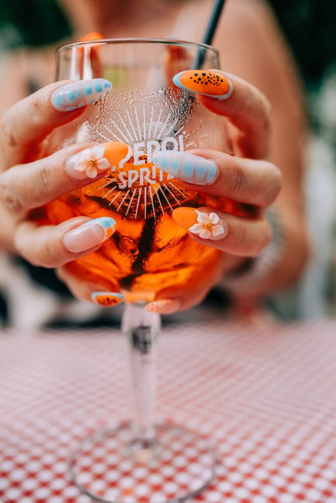 Vibrant summer cocktail with nail art design