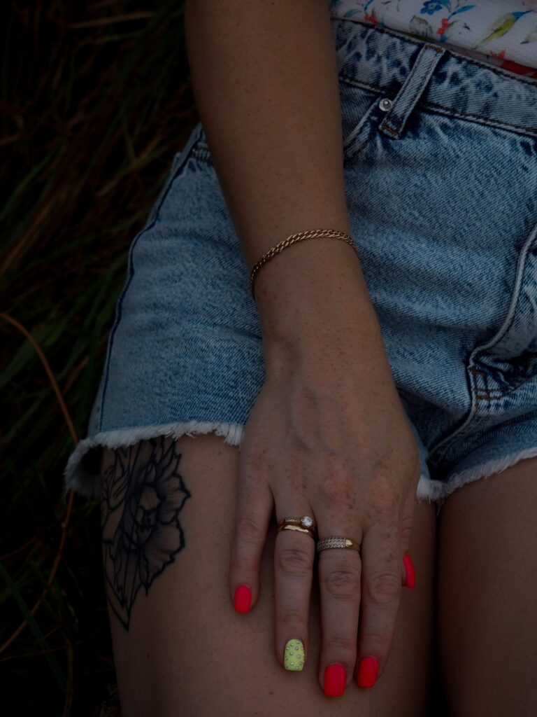 Woman hand with rings bracelet and varnished nails
