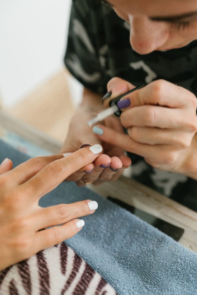 person applying manicure